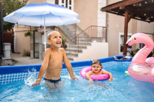 istock Two joyful children having fun in the swimming pool 2149627926