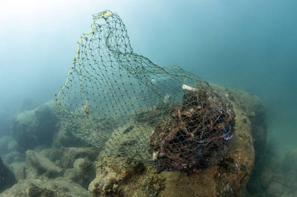Abandoned fishing net and plastic garbage in the sea