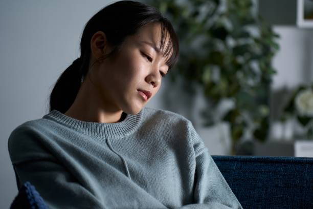 istock A woman thinking in a dark room 2149628220
