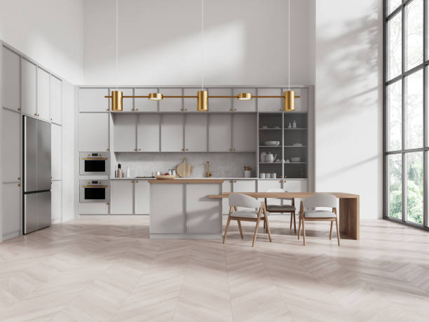 istock Stylish home kitchen interior with bar island and cabinet, panoramic window 2149628640