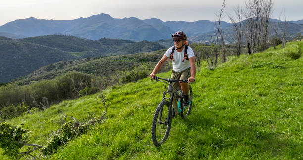 istock Mature man e-biking in lush meadow 2149629035