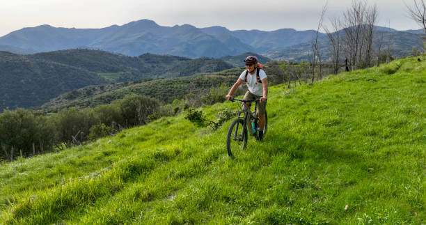 istock Mature man e-biking in lush meadow 2149629097