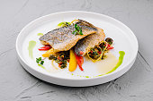 Gourmet pan-seared fish with vegetable garnish