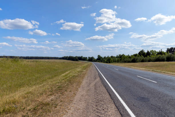 istock paved road along and blue sky 2149630641