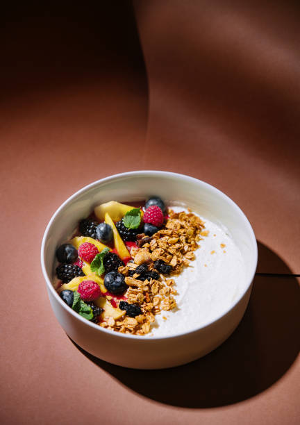 istock Fresh fruit yogurt bowl on elegant brown background 2149630830