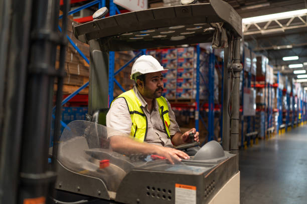 istock Warehouse worker driver in uniform delivery and loading pallet product. 2149630989