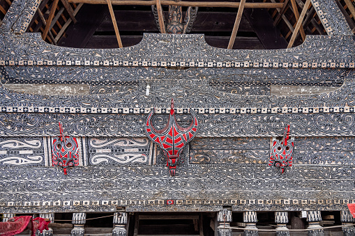 Samosir Island, Lake Toba, North Sumatra, Indonesia - January 31th 2024:  Traditional Batak ornaments of a facade of a wooden residential house