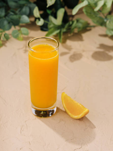istock Fresh orange juice in a tall glass with slice 2149631520