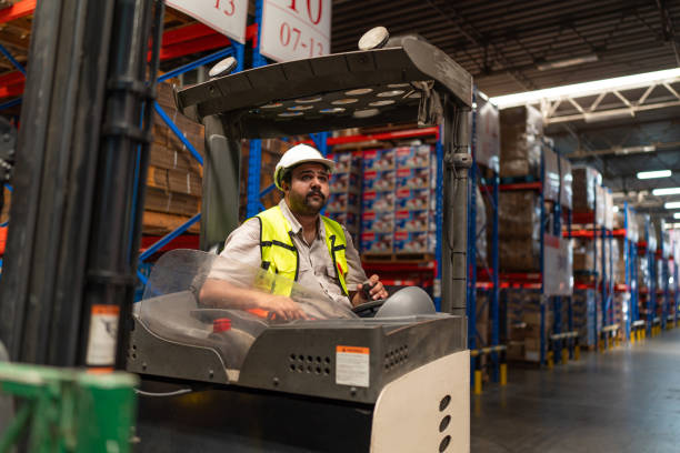 istock Warehouse worker driver in uniform delivery and loading pallet product. 2149631561