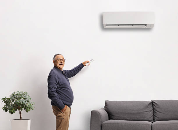 istock Mature man putting on an air conditioning unit 2149632065