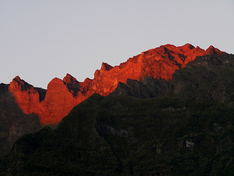 Red light of sunset over the Piton des neiges from Cilaos, Reunion, France