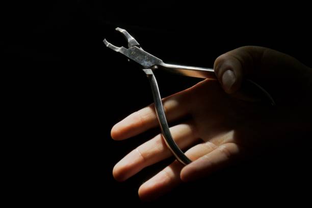istock Orthodontist pliers, dentist's tool on female hand 2149633348