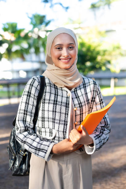 istock Young female Muslim student smiling and looking at camera in campus university 2149633740