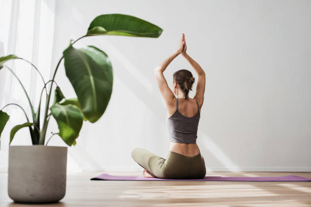istock Woman doing relaxation exercises, practicing yoga, meditating at home 2149633797