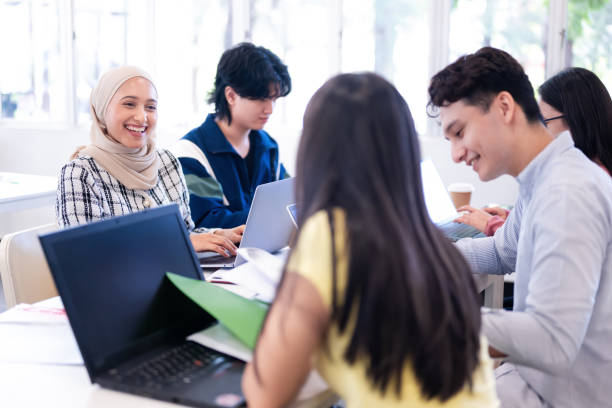 istock Group of multi ethnic young university students study with laptops in classroom 2149634054