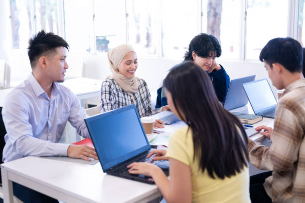 istock Group of multi ethnic young university students study with laptops in classroom 2149634055