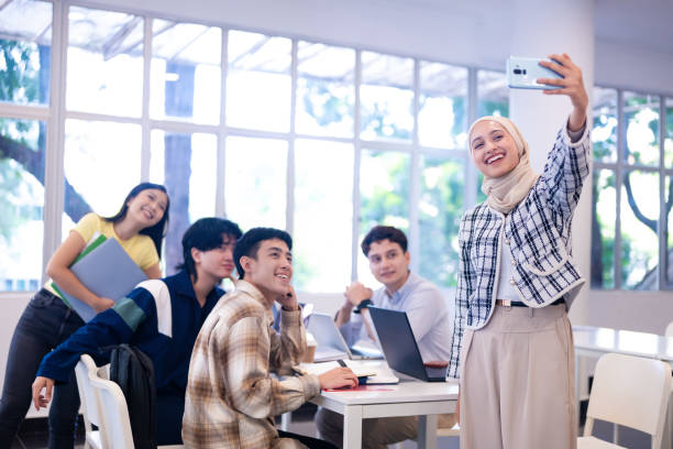 istock Group of multi ethnic young university students taking selfie photos in university campus 2149634069