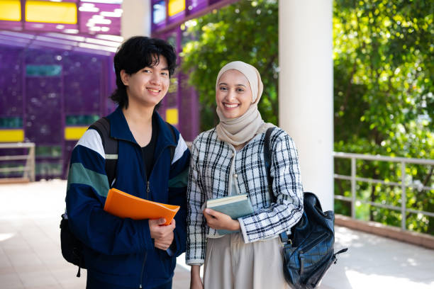 istock Portrait of two diverse young university students communicating and discussion on school assignment after class in university campus 2149634097