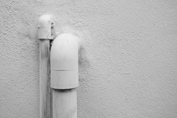 PVC pipes that protruded from the cement wall caused by the water system inside the house.