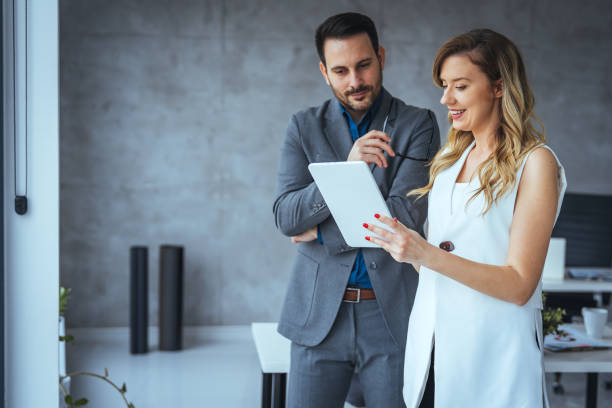 istock Shot of two young colleagues having a discussion in modern office. 2149639955