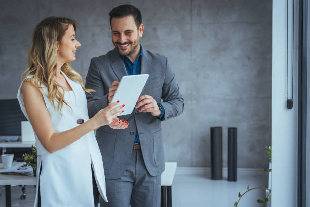 istock Happy business colleagues in modern office using tablet 2149639957
