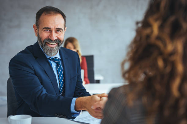 istock Businessman shaking a womans hand in the office. 2149640102