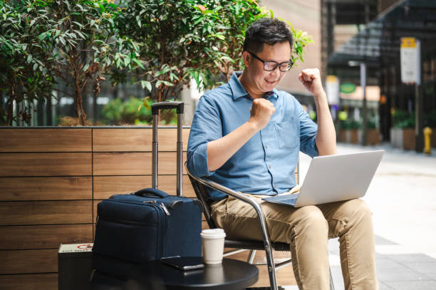 istock Café Triumph: Asian Freelancer's Victorious Workspace 2149640747