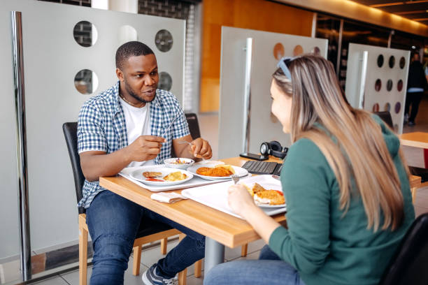istock Two colleagues having lunch break at restaurant and analysing their work while having a meal 2149641913