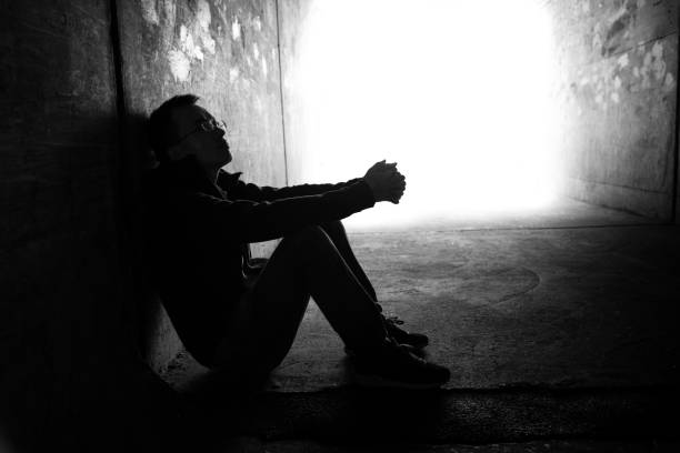 istock One man sitting in the dark tunnel 2149642583