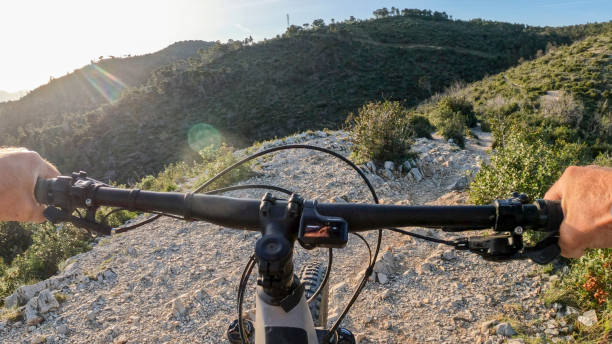 istock POV of e-biking along lush pathway 2149644669