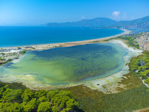 Loggerhead turtle spawning site Iztuzu Beach. It is known for its blue crab and golden sands. Next to Dalyan delta. Drone view from above valley of beach and mountains. Tourist place in Turzia.