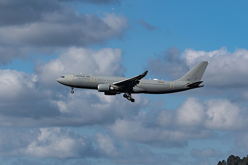 Airbus A330 MRTT military transport and refueling aircraft of the Spanish Air Force performing training maneuvers during a sunny day with blue sky and clouds in Bilbao, Spain. Concept: defense, war, army, air force.