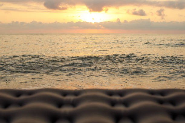 Sea beach and sky cloud background with blurry Inflatable mattress in foreground