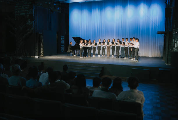 istock Asian Chinese Choir chorus performance group Singing on stage with audience watching 2149646477