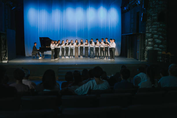 istock Asian Chinese Choir chorus performance group Singing on stage with audience watching 2149646514