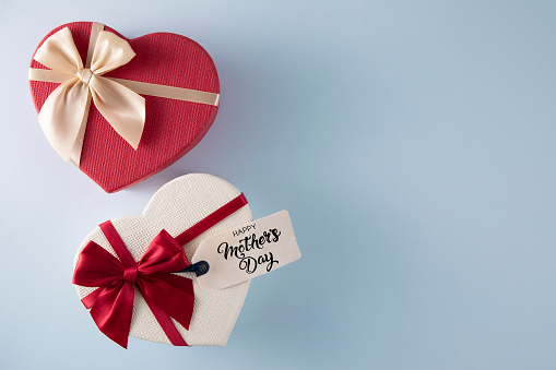 Happy Mother's Day gift tag with heart shaped gift box on blue background