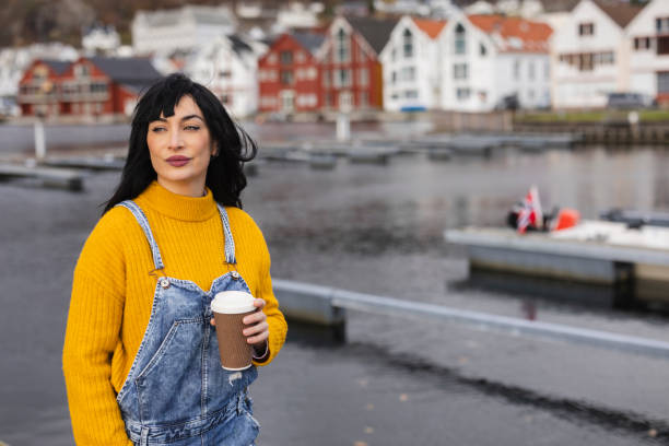 istock Stylish Woman with Coffee Enjoying the Harbor View 2149650672