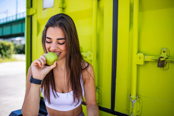 istock Beautiful young woman holding biting fresh apple 2149651970