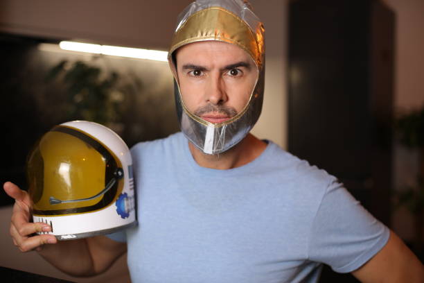 A cute adult man in his early forties is still daydreaming about being an astronaut. Seems like it was his childhood dream.