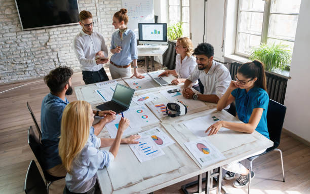 istock Group of multiethnic business people brainstorming, analyzing financial reports in office 2149653231