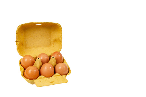 six eggs yellow carton pack,  isolated on white background, with negative space