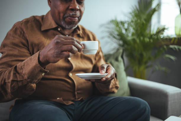 istock Close up shot of an elderly man sitting at home drinking coffee. 2149654820