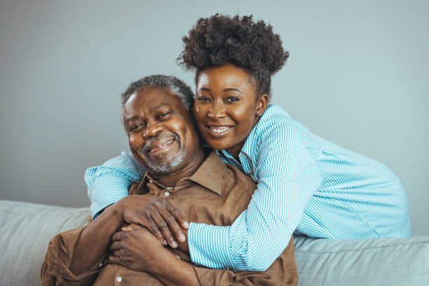 Loving father and daughter together on sofa.