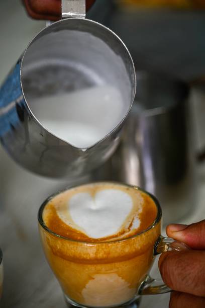 istock Isolated high resolution large of a single steaming hot coffee cup preparation- cappuccino in a restaurant- Israel 2149656596