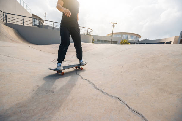 istock Skateboarder skateboarding at skatepark in city 2149656919