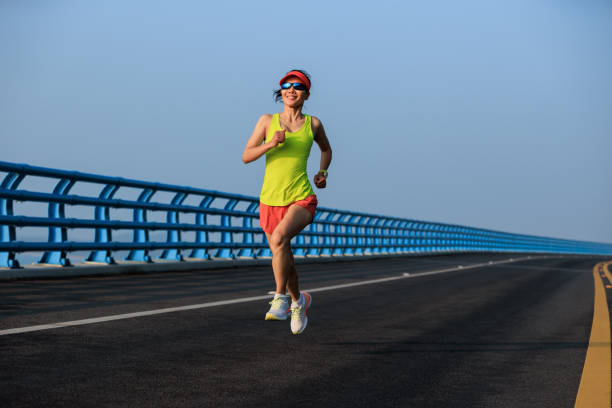 istock Fitness woman runner running on seaside bridge 2149657015