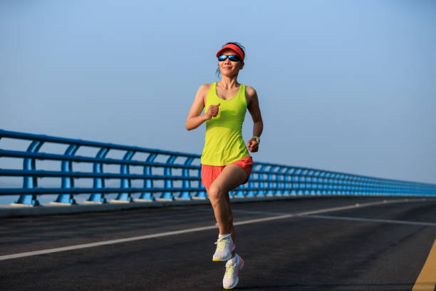 istock Fitness woman runner running on seaside bridge 2149657043