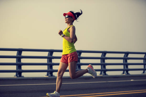 istock Fitness woman runner running on seaside bridge 2149657165