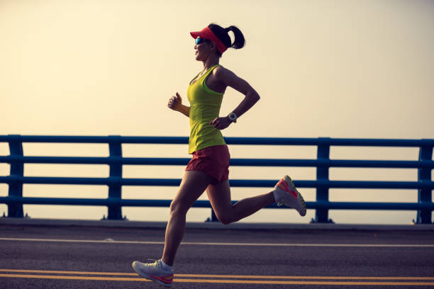istock Fitness woman runner running on seaside bridge 2149657194