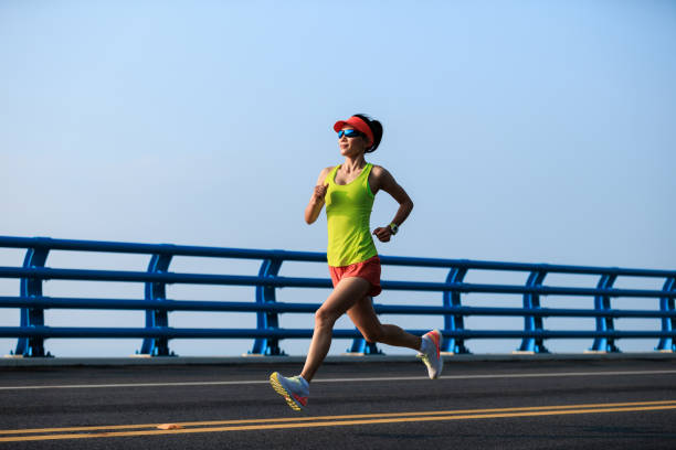 istock Fitness woman runner running on seaside bridge 2149657250